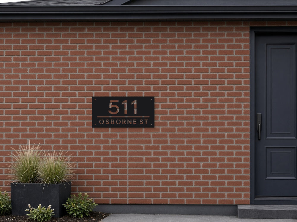 Divider bar address sign mounted on a red brick wall beside the front door