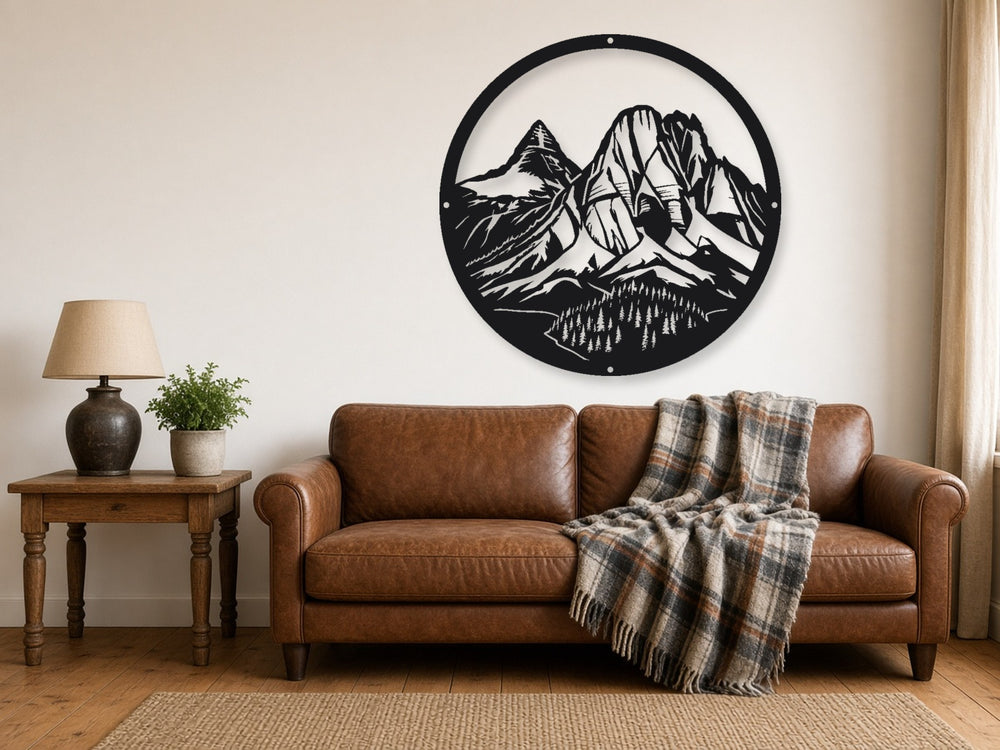 Mountain Valley round metal wall art hung above a leather sofa in a cabin living room