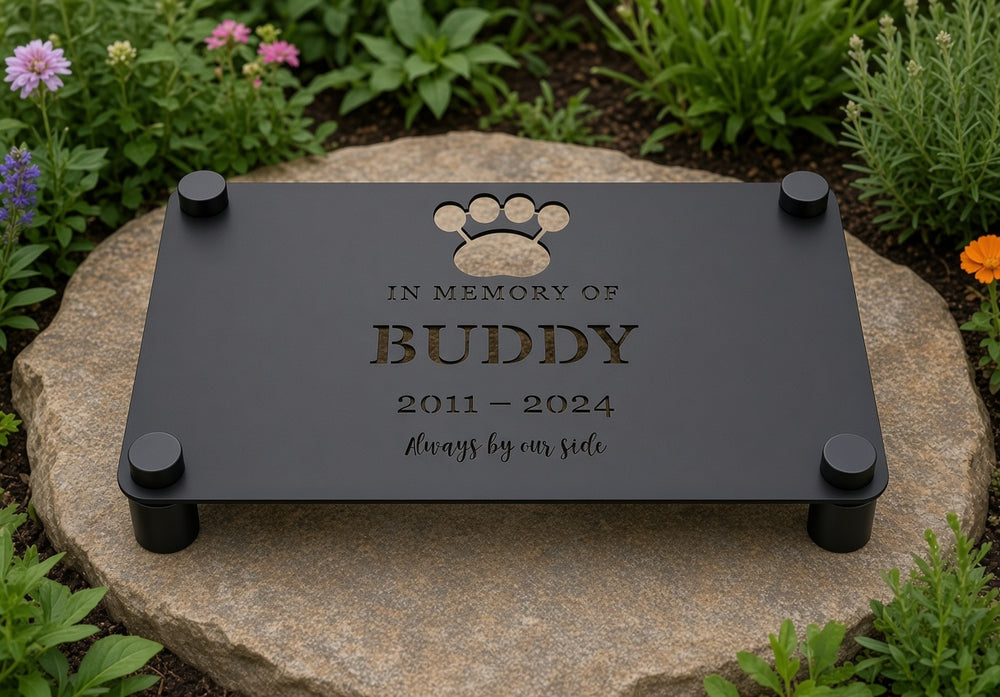 Pet memorial plaque on black standoffs on a stone slab in a garden