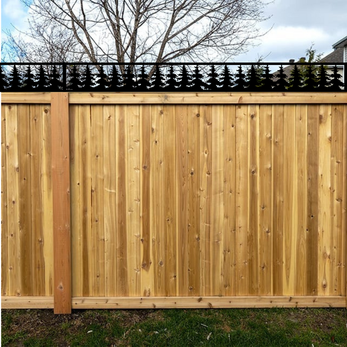 Pine trees metal fence topper on wood privacy fence